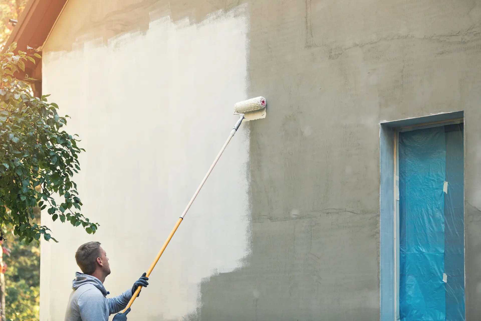 Pintor trabajando en una fachada en Benalmádena